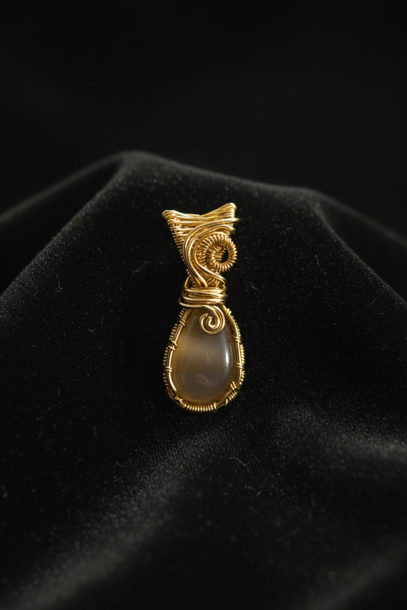 White chalcedony wirewrapped pendant in gold tone