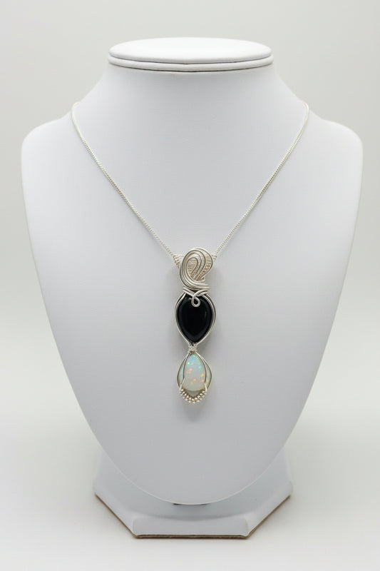 Black onyx and opal hourglass in silver